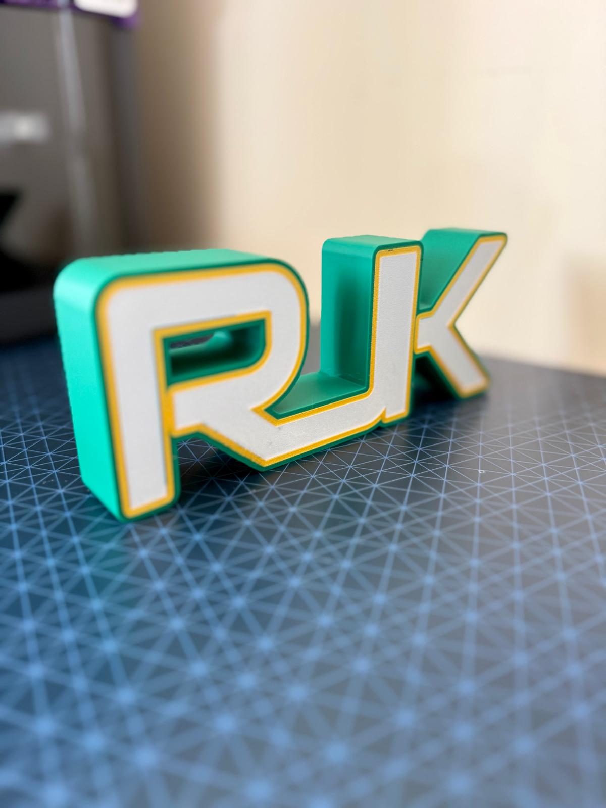 Personalised RGB LED initials light glowing green, 3D printed in Galway