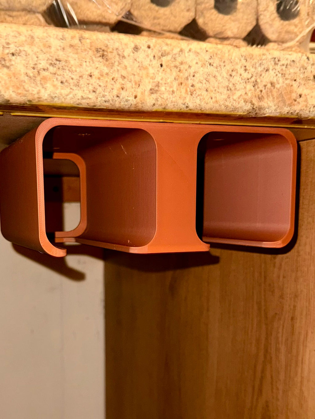 3D printed cordless tool holder mounted on a workshop wall